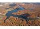 An aerial view of the lake surrounded by colorful autumn trees at 7809 S Solitude Ln, Trafalgar, IN 46181