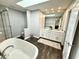 A bright bathroom with a soaking tub, shower, double vanity, and a large mirror at 7809 S Solitude Ln, Trafalgar, IN 46181