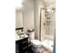 Modern bathroom with walk-in tile shower, glass door, and updated fixtures at 7809 S Solitude Ln, Trafalgar, IN 46181
