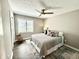 Cozy bedroom with a ceiling fan, natural light, neutral paint and comfortable decor at 7809 S Solitude Ln, Trafalgar, IN 46181