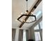 Close up of a modern chandelier and skylight in a living room with cathedral ceilings at 7809 S Solitude Ln, Trafalgar, IN 46181