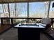 Covered deck with fire pit, offering a relaxing space with views of the lake at 7809 S Solitude Ln, Trafalgar, IN 46181