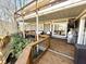 Multi-level deck featuring a sitting area, grill, TV, and an outdoor hot tub at 7809 S Solitude Ln, Trafalgar, IN 46181