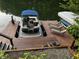 Pontoon boat and dock with lounge chairs overlooking the lake, ideal for summer fun at 7809 S Solitude Ln, Trafalgar, IN 46181