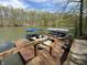 Lakefront home boasts a private dock with pontoon boat and inviting lounging areas at 7809 S Solitude Ln, Trafalgar, IN 46181