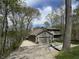 Exterior shot of home with attached garage and ample parking, surrounded by trees at 7809 S Solitude Ln, Trafalgar, IN 46181