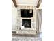 Stone fireplace with mantle and tv, neutral decor, and light-colored accents at 7809 S Solitude Ln, Trafalgar, IN 46181