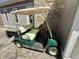 Green golf cart parked next to a stone wall, providing convenient transportation around the property at 7809 S Solitude Ln, Trafalgar, IN 46181