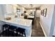 Well-lit kitchen featuring a large island, stainless steel appliances, and a breakfast bar with modern stools at 7809 S Solitude Ln, Trafalgar, IN 46181