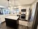 Bright, updated kitchen with stainless steel appliances, island, white cabinets, and modern fixtures at 7809 S Solitude Ln, Trafalgar, IN 46181