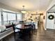 Eat-in kitchen with attached breakfast nook, large window, and white cabinets at 7809 S Solitude Ln, Trafalgar, IN 46181