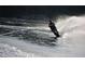 Action shot of a Personal water skiing on a lake, showcasing an active lifestyle and the allure of lakeside living at 7809 S Solitude Ln, Trafalgar, IN 46181