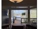Inviting lake view from inside a lovely home, extending to an outdoor deck with grill at 7809 S Solitude Ln, Trafalgar, IN 46181
