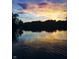 Beautiful sunset reflecting on the lake, highlighting the serene and picturesque atmosphere of the waterfront at 7809 S Solitude Ln, Trafalgar, IN 46181