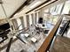 Open-concept living room with cathedral ceilings, exposed beams, and access to the deck at 7809 S Solitude Ln, Trafalgar, IN 46181