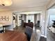 Open-concept living room featuring hardwood floors, abundant natural light, and a glimpse into a home office at 7809 S Solitude Ln, Trafalgar, IN 46181