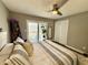 Bright main bedroom with slider to deck, neutral decor, and ceiling fan at 7809 S Solitude Ln, Trafalgar, IN 46181