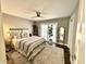 Spacious main bedroom with ceiling fan, sliding door to balcony, and neutral color palette at 7809 S Solitude Ln, Trafalgar, IN 46181