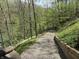 Scenic gravel path lined with trees leading down to a lake, blending nature and property at 7809 S Solitude Ln, Trafalgar, IN 46181