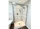 Stylish glass enclosed shower with tiled walls, a shower niche, and a modern shower head at 7809 S Solitude Ln, Trafalgar, IN 46181