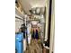 Functional utility room featuring a water softener, HVAC equipment, and storage shelving at 7809 S Solitude Ln, Trafalgar, IN 46181