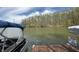 Scenic lake view with a boat and a 'For Sale' sign, showcasing a waterfront property opportunity at 7809 S Solitude Ln, Trafalgar, IN 46181
