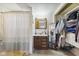 Bathroom features a shower-tub combo, wood vanity and closet with ample shelving at 8017 Wallingwood Dr, Indianapolis, IN 46256