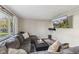 Cozy living room featuring a comfortable gray sectional couch and a wall-mounted television at 8017 Wallingwood Dr, Indianapolis, IN 46256