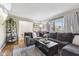 Comfortable living room showcasing a large sectional sofa, hardwood floors, and ample natural light at 8017 Wallingwood Dr, Indianapolis, IN 46256
