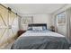 Serene main bedroom with a comfortable bed, barn-style closet door and natural light from two windows at 8017 Wallingwood Dr, Indianapolis, IN 46256