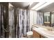 Bathroom with neutral patterned shower curtain, vanity with mirror, and a toilet at 8075 N Cardinal W Cv, Indianapolis, IN 46256