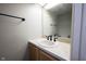A bathroom featuring a sink and mirror with a tan countertop at 8075 N Cardinal W Cv, Indianapolis, IN 46256