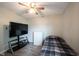 Bedroom featuring wood grain laminate flooring, neutral paint, and a large tv at 8075 N Cardinal W Cv, Indianapolis, IN 46256