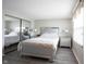 A bright bedroom with a large closet, wood grain laminate flooring, and neutral paint at 8075 N Cardinal W Cv, Indianapolis, IN 46256