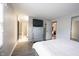 Bedroom featuring wood grain laminate flooring, neutral paint, and an en-suite bath at 8075 N Cardinal W Cv, Indianapolis, IN 46256