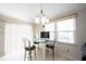 Bright dining area features a glass table, four chairs, and a chandelier at 8075 N Cardinal W Cv, Indianapolis, IN 46256