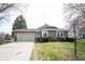 Charming one-story home with a two-car garage, a well-maintained lawn, and lush landscaping in a serene setting at 8075 N Cardinal W Cv, Indianapolis, IN 46256
