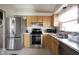 Updated kitchen with stainless steel appliances, white countertops, and wooden cabinets at 8075 N Cardinal W Cv, Indianapolis, IN 46256