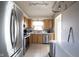 Kitchen with stainless steel appliances, wood cabinets and a sink underneath a bright window at 8075 N Cardinal W Cv, Indianapolis, IN 46256