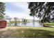 Picturesque lake view surrounded by well-maintained lawns and mature trees creating a serene and private backyard setting at 8075 N Cardinal W Cv, Indianapolis, IN 46256