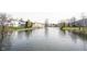 Expansive lake view showcasing tranquil water surrounded by residential properties in a peaceful neighborhood setting at 8075 N Cardinal W Cv, Indianapolis, IN 46256