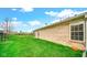 Green backyard featuring lush green grass and a glimpse of the house's brick exterior at 8242 Frankdale Ct, Indianapolis, IN 46259