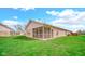 Expansive backyard featuring a well-maintained lawn and the house's brick exterior at 8242 Frankdale Ct, Indianapolis, IN 46259