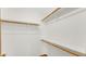 Spacious walk-in closet with wooden rods for ample storage and organization at 8242 Frankdale Ct, Indianapolis, IN 46259