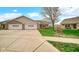 Charming single-story home featuring a two-car garage, brick accents, and a well-manicured lawn at 8242 Frankdale Ct, Indianapolis, IN 46259