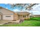 Well-maintained single-story home with two car garage and blossoming tree at 8242 Frankdale Ct, Indianapolis, IN 46259