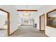 Spacious living room with vaulted ceiling, chandelier, and view to kitchen at 8242 Frankdale Ct, Indianapolis, IN 46259