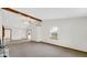 Open living room features large window and vaulted ceiling with exposed beams at 8242 Frankdale Ct, Indianapolis, IN 46259