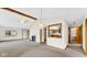 Bright living room features beamed ceilings, fireplace, and a pass-through to the kitchen at 8242 Frankdale Ct, Indianapolis, IN 46259