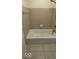 Bathroom showing a bathtub with tiled walls, a shower head, and tile floors for a clean and functional space at 8277 Sobax Dr, Indianapolis, IN 46268